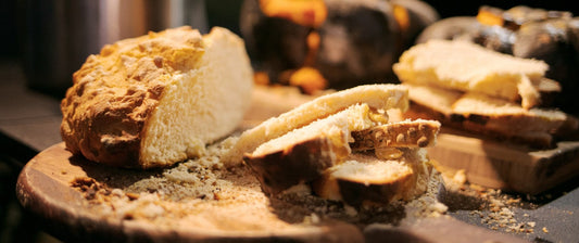 Traditional Australian damper bread sliced and served on a wooden board.