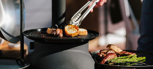 Bread and steak on an Ozpig Series 2 chargrill, with asparagus on the side warming plate