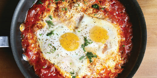 One-pot continental savoury eggs with baked eggs simmered in tomato sauce, prepared in a pan for an easy breakfast.