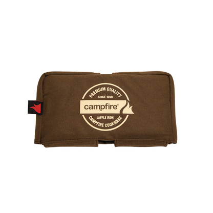The Campfire brand Canvas Bag Jaffle Iron Double Jumbo is a brown padded cover featuring a cream circular logo with the words "Premium Quality, Campfire, Jaffle Iron, Campfire Cookware," and a red tag on the left side. Designed to fit your Jumbo Double Jaffle Iron, this durable canvas bag offers padded walls for extra protection. The background is white.