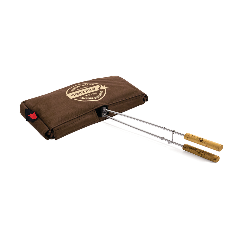 Introducing the Campfire Canvas Bag Jaffle Iron Double Jumbo: a brown jumbo-sized double jaffle iron featuring two sturdy wooden handles and padded walls, perfect for toasting or grilling over a campfire. It comes complete with a durable canvas bag, making it the ideal companion for all your outdoor culinary adventures.