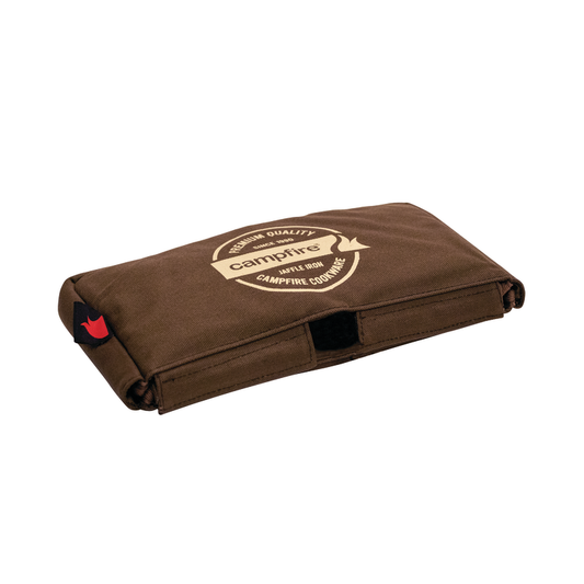 The Campfire Canvas Bag Jaffle Iron Double Jumbo is a folded brown canvas bag with padded walls, featuring a circular Campfire logo and the words "spill now, campfire compliant" printed on top—perfect for storing your Jumbo Double Jaffle Iron.