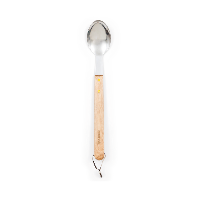 A Campfire 22pc BBQ Set stainless steel spoon with a light wooden handle and two brass rivets, featuring a leather loop at the end—ideal for outdoor cooking—photographed on a white background.
