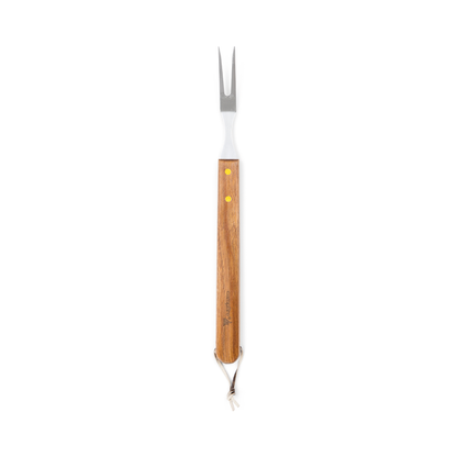 The Campfire 22pc BBQ Set includes a metal carving fork with two prongs and a long wooden handle, accented by two yellow rivets and finished with a leather strap at the end. Photographed on a white background, this durable stainless steel fork is a practical addition for reliable outdoor cooking.