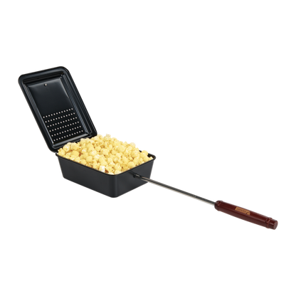A Campfire Popcorn Pan in black, featuring a hinged lid and a long wooden handle, is filled with freshly fire-popped popcorn and sits on a white background—perfect for campfire cooking.