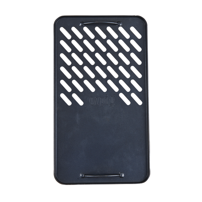 The Ozpig Fire Pit Solid/Grill Cooking Plate by Ozpig is a black, rectangular grilling accessory crafted from heavy-duty steel, designed with diagonal slits on the upper half and two small side handles—ideal for use as a grill cooking plate with your Ozpig 3 in 1 Flat Pack Fire Pit.