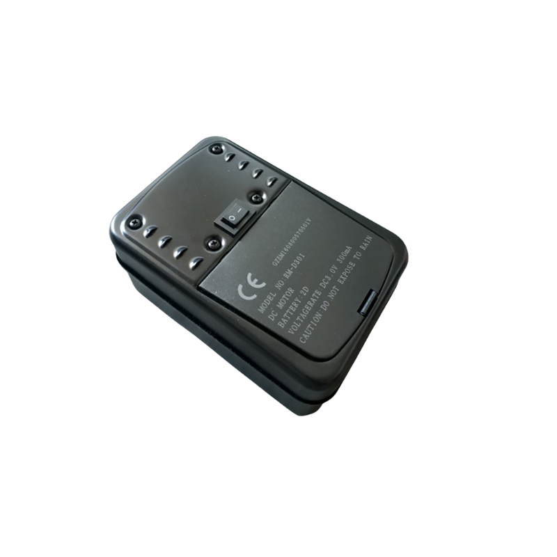 An Ozpig Rotisserie Motor, a black plastic electronic device by Ozpig, featuring a switch and screw heads on the surface, as well as CE marking and technical labeling, shown isolated on a white background.