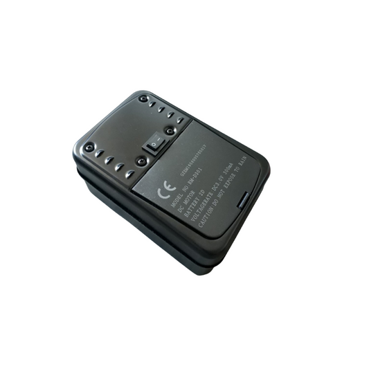 An Ozpig Rotisserie Motor, a black plastic electronic device by Ozpig, featuring a switch and screw heads on the surface, as well as CE marking and technical labeling, shown isolated on a white background.