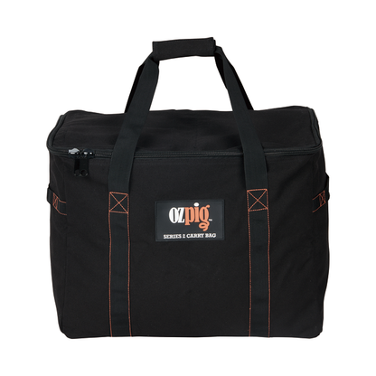 The Ozpig Series 2 Heavy Duty Storage Bag by Ozpig is made from black heavy-duty cotton canvas with orange stitching. It features two handles, a zippered top, and a front pocket displaying the logo and series label. Internal storage pockets are included to help keep your accessories organised.