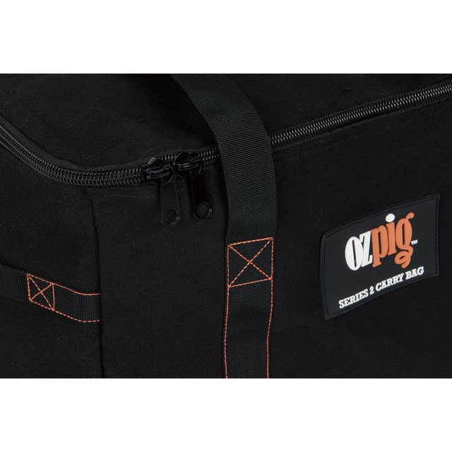 Close-up of the Ozpig Series 2 Heavy Duty Storage Bag by Ozpig, made from durable black cotton canvas with orange stitching, sturdy black handles, dual zipper pulls, and a prominent Ozpig logo patch on the side. The bag includes internal storage pockets for convenient organization.