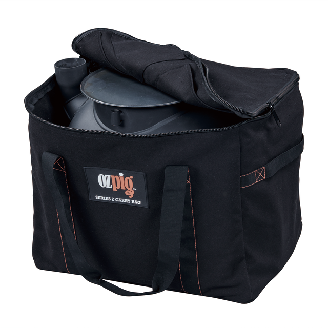 A black heavy duty cotton canvas storage bag with handles, partially open to reveal a metal Ozpig grill inside. The front label reads "Ozpig Series 2 Heavy Duty Storage Bag." Designed for convenience by Ozpig, this bag also features internal storage pockets to keep your accessories organised.