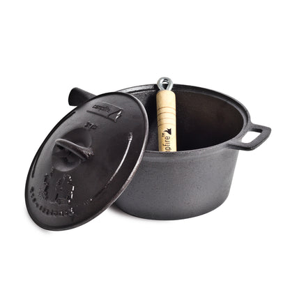 A Campfire 3 Quart Cast Iron Saucepan with exceptional heat retention is on display, its lid slightly ajar to reveal a removable wooden handle tool inside. The saucepan features two sturdy side handles, while the lid boasts a practical handle and embossed branding.