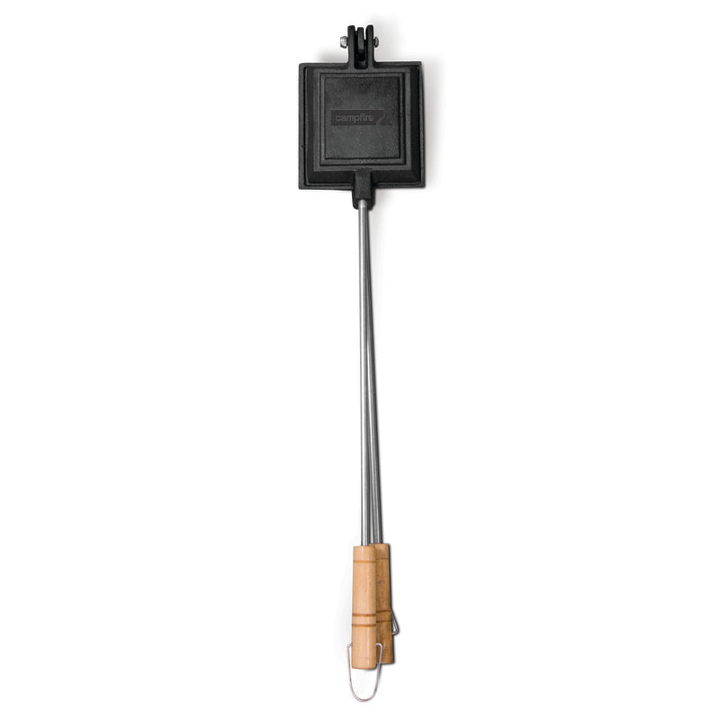 The Campfire Jaffle Iron Jumbo Single is a pre-seasoned, square cast iron sandwich maker featuring a long metal handle with a wooden grip, ideal for cooking sandwiches or pies over an open fire during campfire adventures.