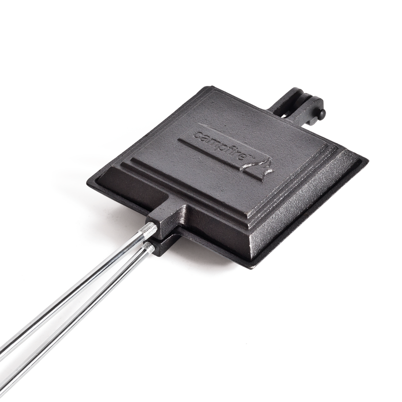 The Campfire Jaffle Iron Jumbo Single is a sturdy, black cast iron sandwich toaster featuring a square design and two long metal handles. Shown on a white background, it’s perfect for campfire cooking and brings classic outdoor meals to life.