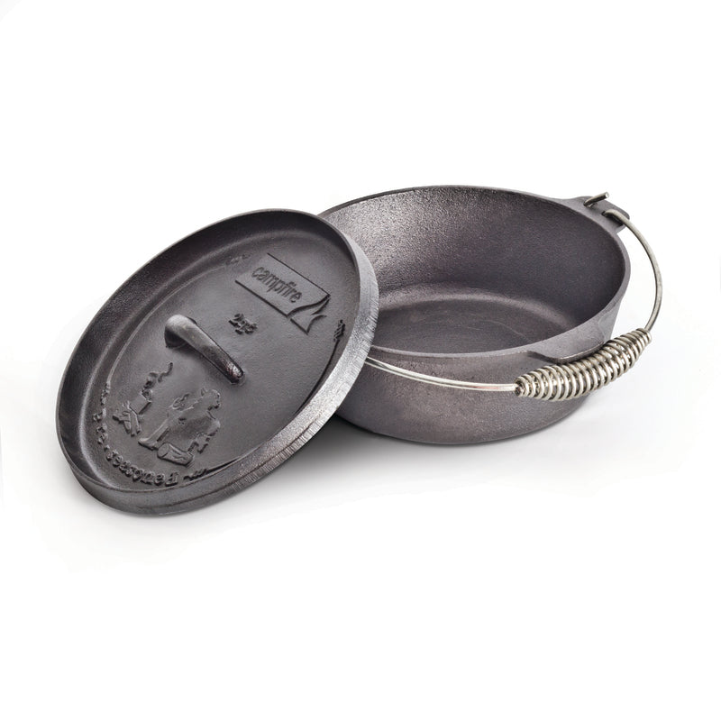 A black, pre-seasoned 2 quart Camp Oven by Campfire with a handle and a partially open lid. The lid features embossed outdoor scenery and the "Campfire" brand name, making it ideal for outdoor cooking adventures.
