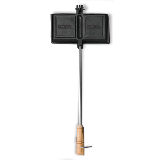 The Campfire Jaffle Iron Jumbo Double is crafted from cast iron and features a double-sided design with a long metal handle and wooden grip, making it perfect for cooking hearty campfire meals over an open fire.