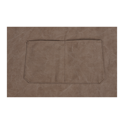 Close-up of the Ozpig Apron’s brown canvas fabric, showing a centered rectangular pocket divided into two sections and finished with visible dark stitching. Brand: Ozpig.