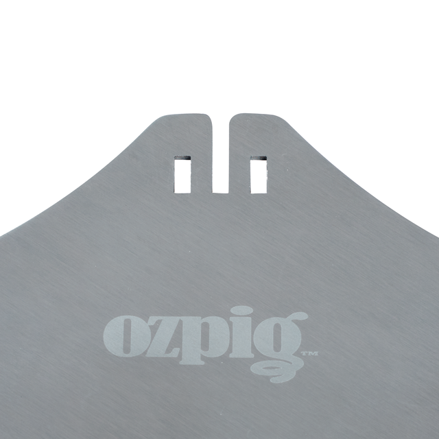 Close-up of a metallic surface with two rectangular notches and "ozpig" printed in white lowercase letters, part of the Ozpig Kebab Rotisserie Set featuring durable stainless steel skewers from Ozpig.