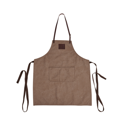 The Ozpig Apron by Ozpig is a brown canvas apron with an adjustable neck strap, two front pockets, long waist ties, and leather detailing, shown flat on a white background.