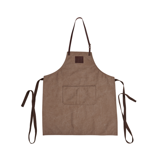 The Ozpig Apron by Ozpig is a brown canvas apron with an adjustable neck strap, two front pockets, long waist ties, and leather detailing, shown flat on a white background.