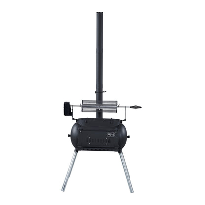 A black, portable outdoor wood stove with a tall chimney, cylindrical body, angled metal legs, and a vented door features a rotisserie attachment on top—ideal for wood-fired cooking and fully compatible with various rotisserie accessories such as the Ozpig Rotisserie Basket Large by Ozpig.