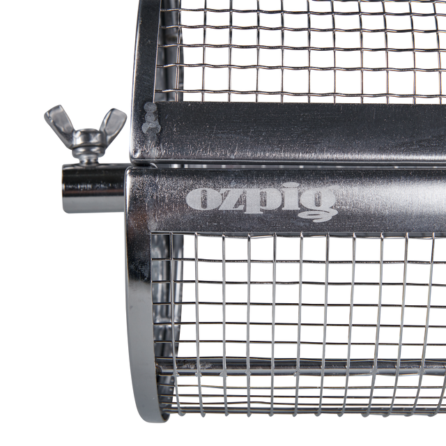 A close-up of the Ozpig Rotisserie Basket Large, a metal mesh rotisserie accessory by Ozpig featuring a wing nut and branded “ozpig” on the surface, designed for wood fired cooking and ideal for grilling or roasting food.