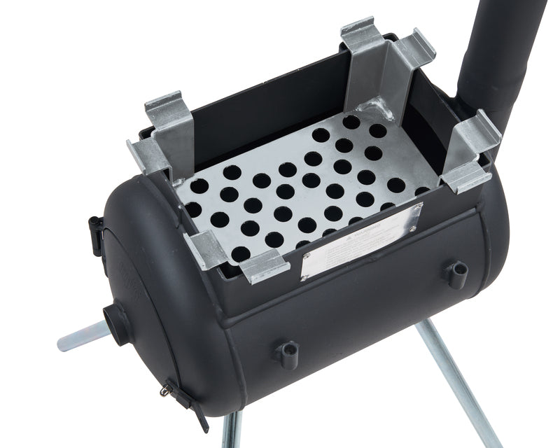 Black metal stove featuring a rectangular open top, a perforated metal grate inside, a cylindrical body, and four support legs. A vertical pipe extends from one side of the stove, ideal for campsite cooking and creating an authentic wood-fired flavour. For added versatility, it is compatible with the Ozpig Traveller Charcoal Basket by Ozpig.