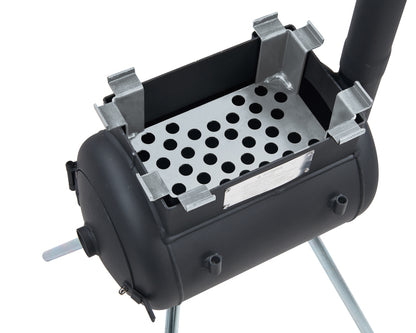 Black metal stove featuring a rectangular open top, a perforated metal grate inside, a cylindrical body, and four support legs. A vertical pipe extends from one side of the stove, ideal for campsite cooking and creating an authentic wood-fired flavour. For added versatility, it is compatible with the Ozpig Traveller Charcoal Basket by Ozpig.